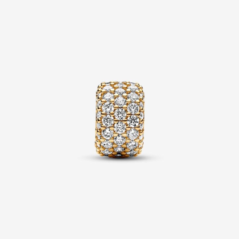 Gold charm with multiple rows of clear stone accents set in a rounded design.